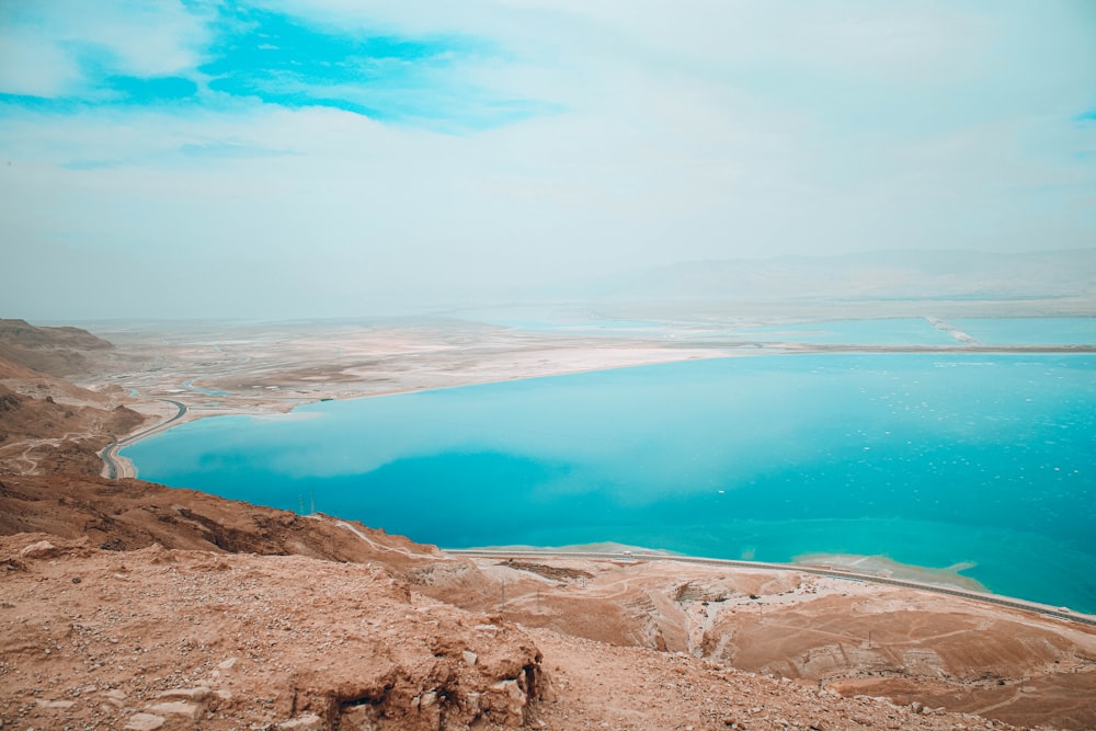 blue body of water under cloudy sky during daytime