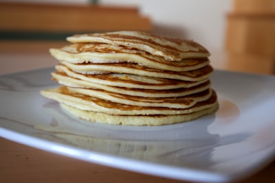 brown and white pastry on white ceramic plate pancake teams background