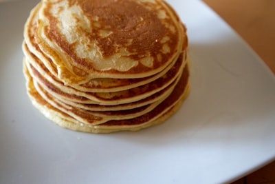 brown and white pastry on white ceramic plate pancake google meet background