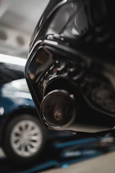 Experienced mechanic performing detailed diagnostics on a vehicle's exhaust system.