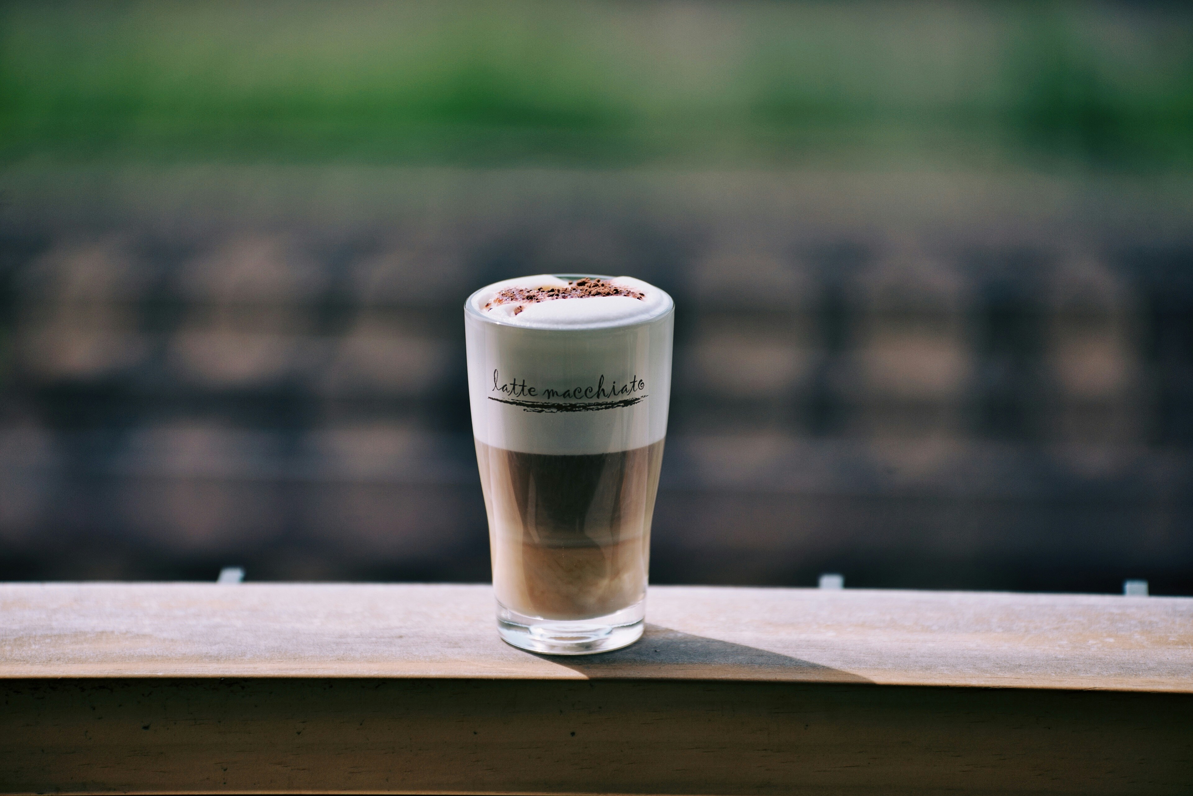 Iced coffee in a tall glass on a ledge