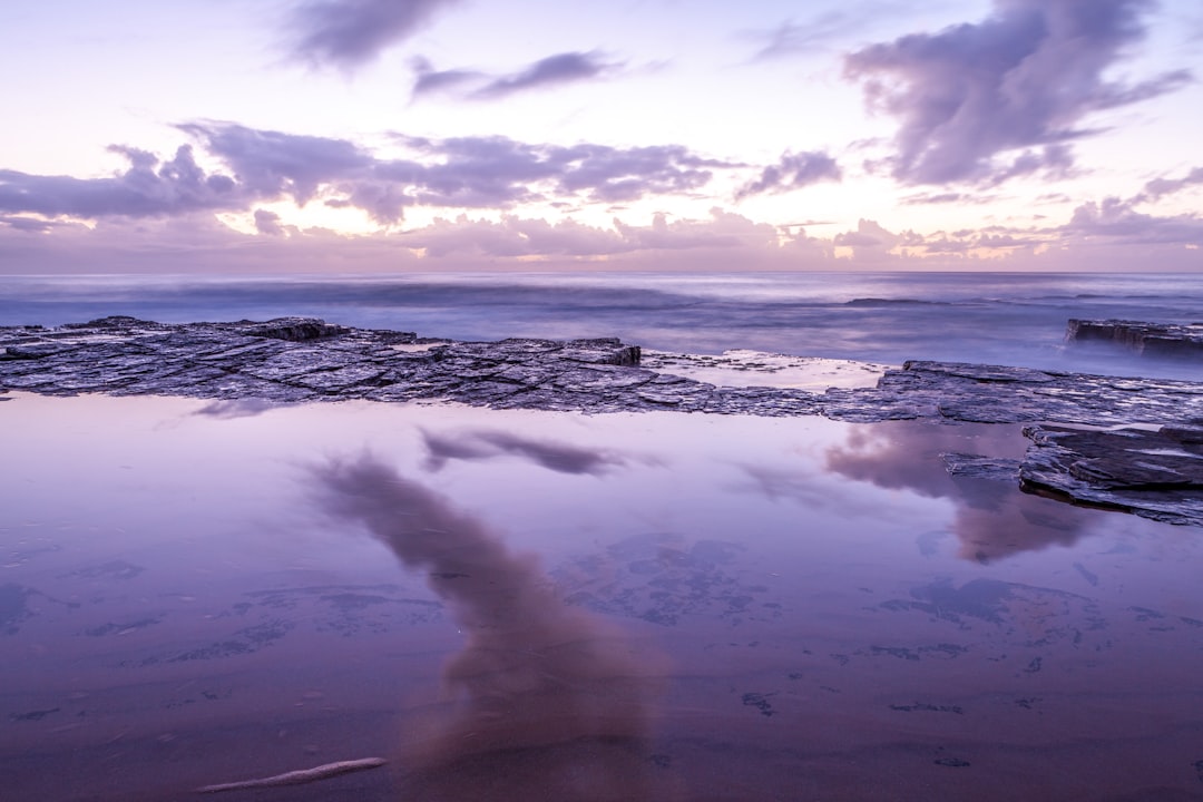 ocean waves crashing on shore during daytime