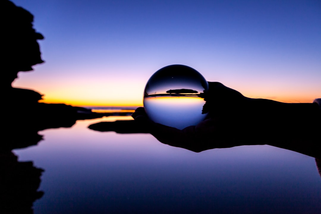 clear glass ball with reflection of sun