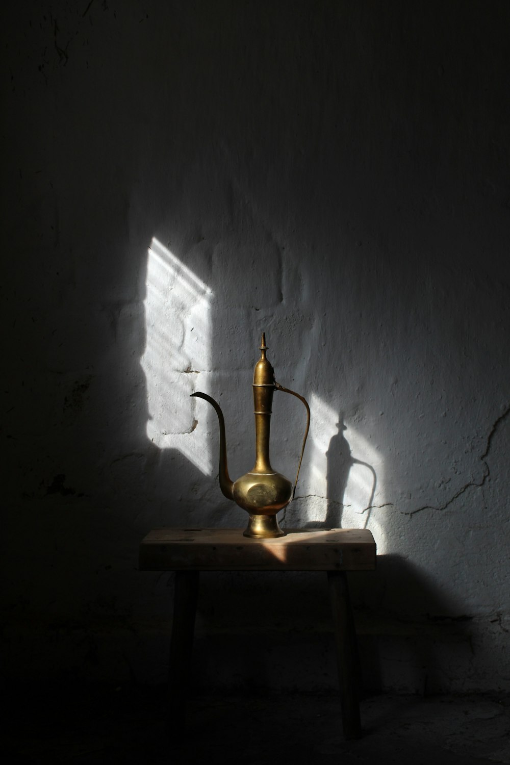 gold vase on brown wooden table