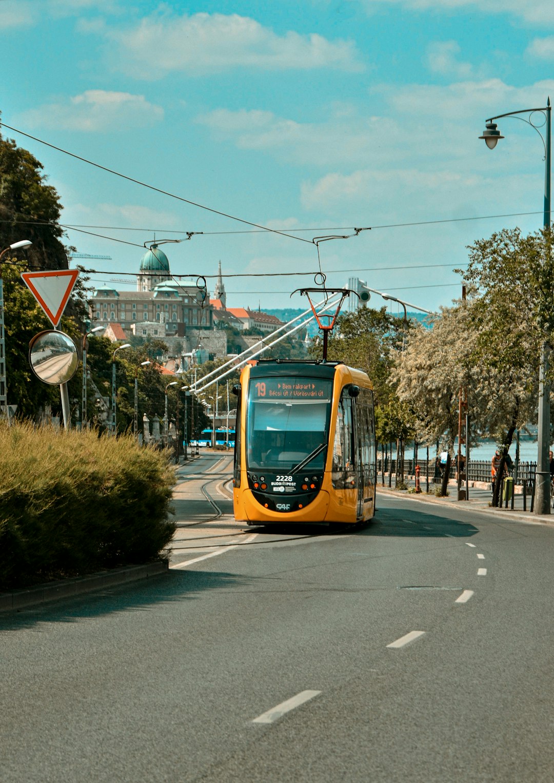 yellow and black tram on road during daytime