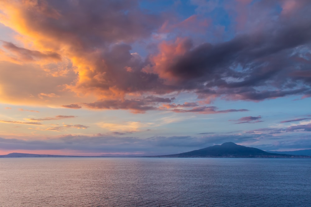 body of water under cloudy sky during daytime