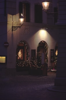 A warmly lit street in Villalba decorated with colorful Christmas lights and festive ornaments.