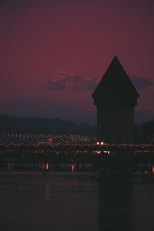silhouette of building near body of water during sunset in Lucerne Switzerland