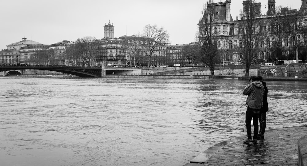 grayscale photo of river near building