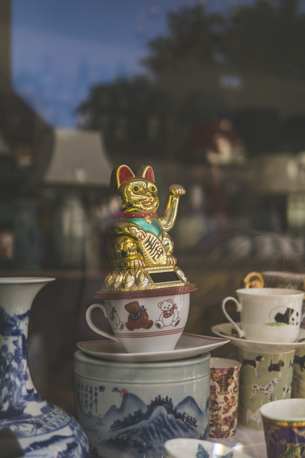 gold and red dragon figurine on white ceramic teacup