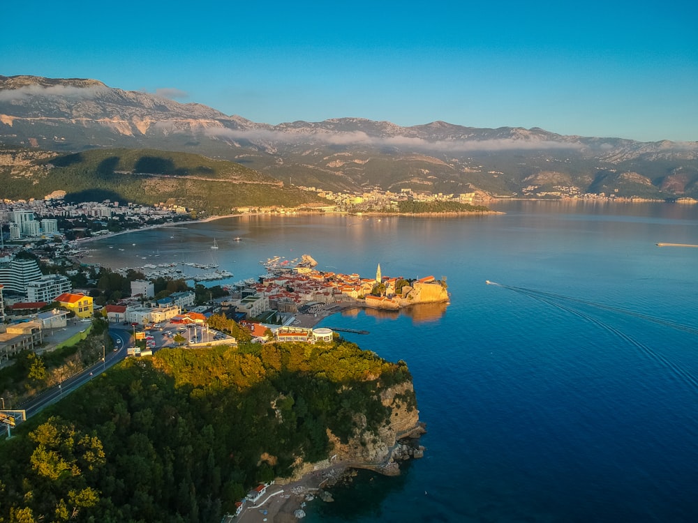 aerial view of green mountain beside body of water during daytime