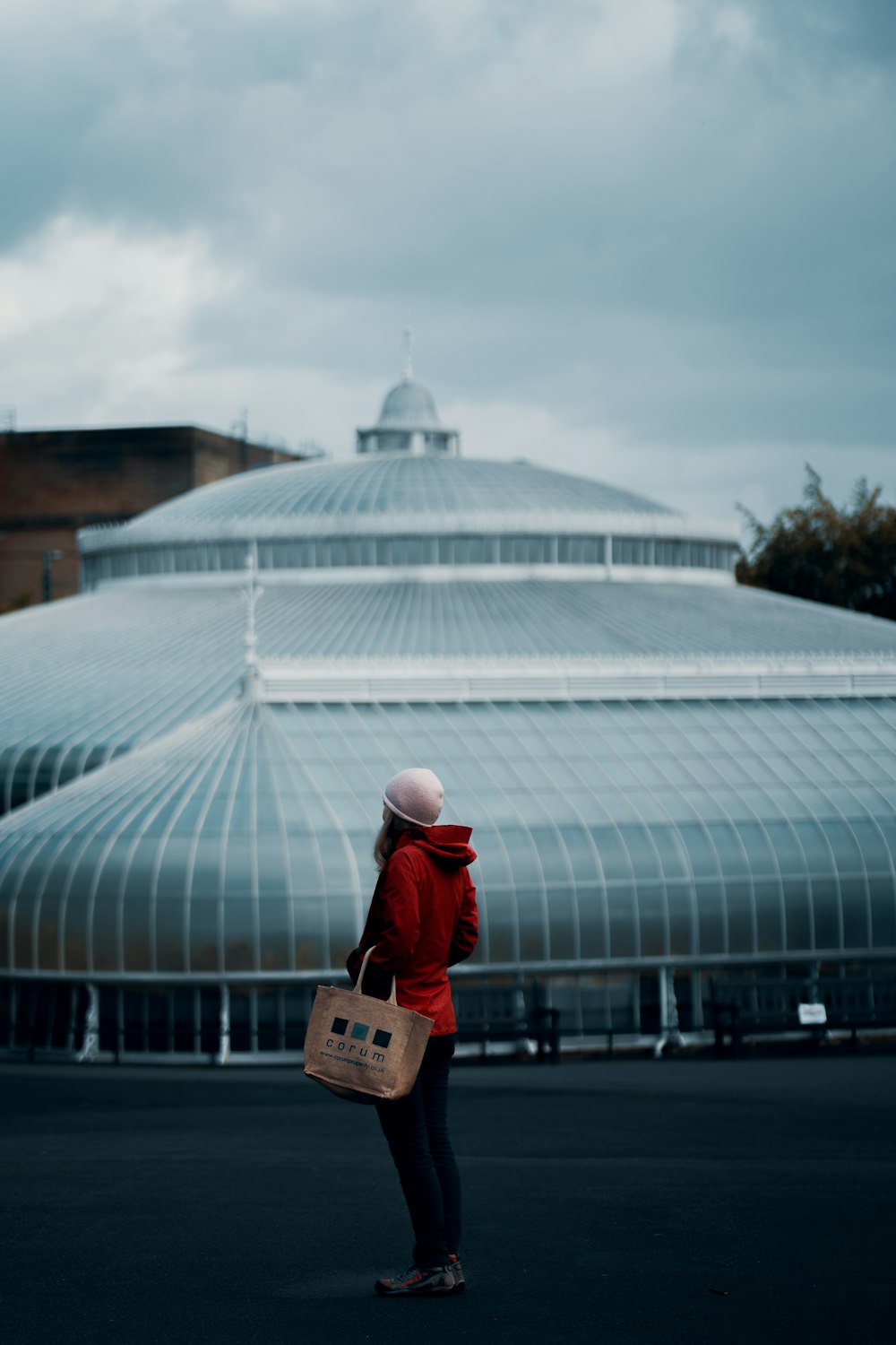 woman in red jacket holding brown wooden box