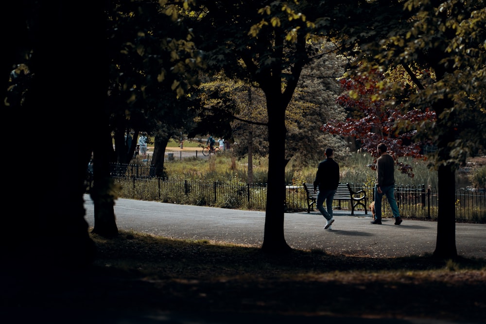 man and woman walking on sidewalk during daytime