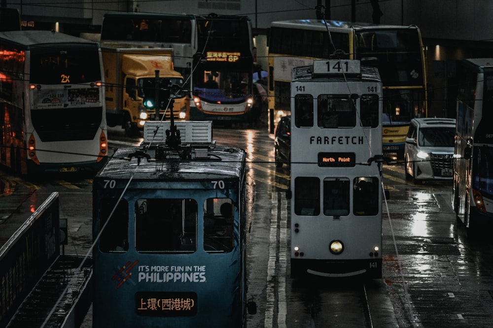 blue and white tram on road during night time