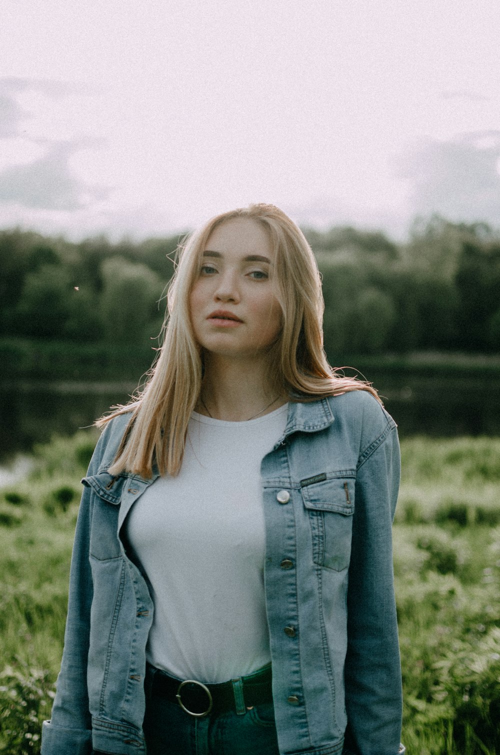 woman in white tank top and blue denim jacket