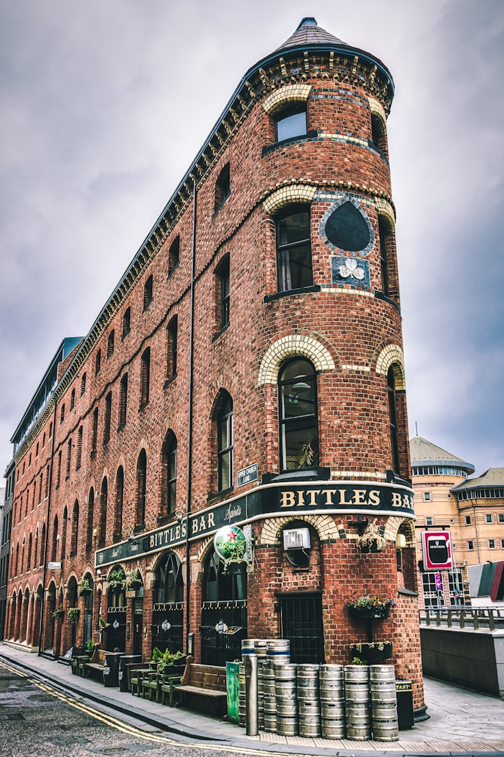 brown brick building under cloudy sky during daytime