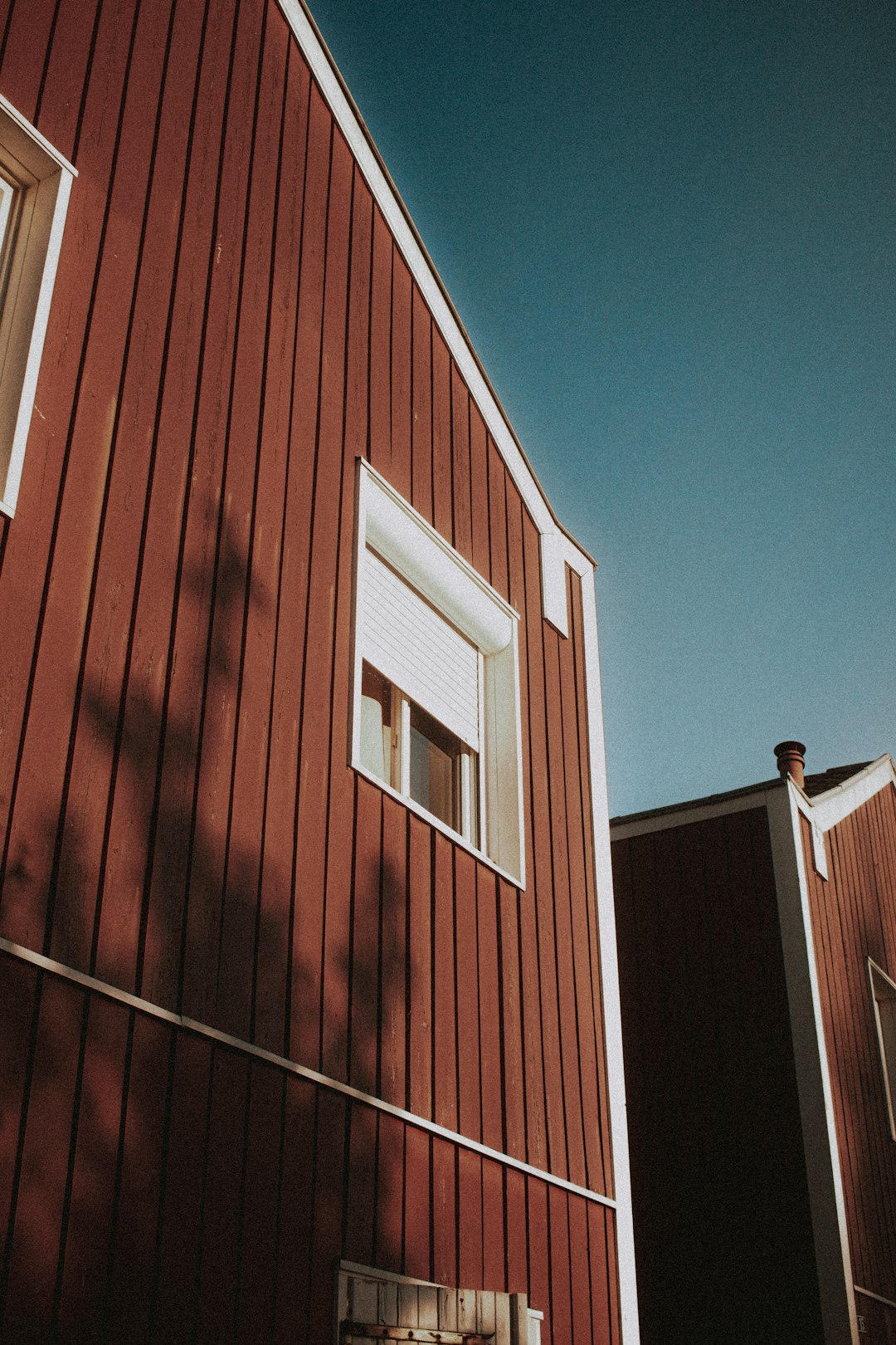 red and white wooden house under blue sky during daytime