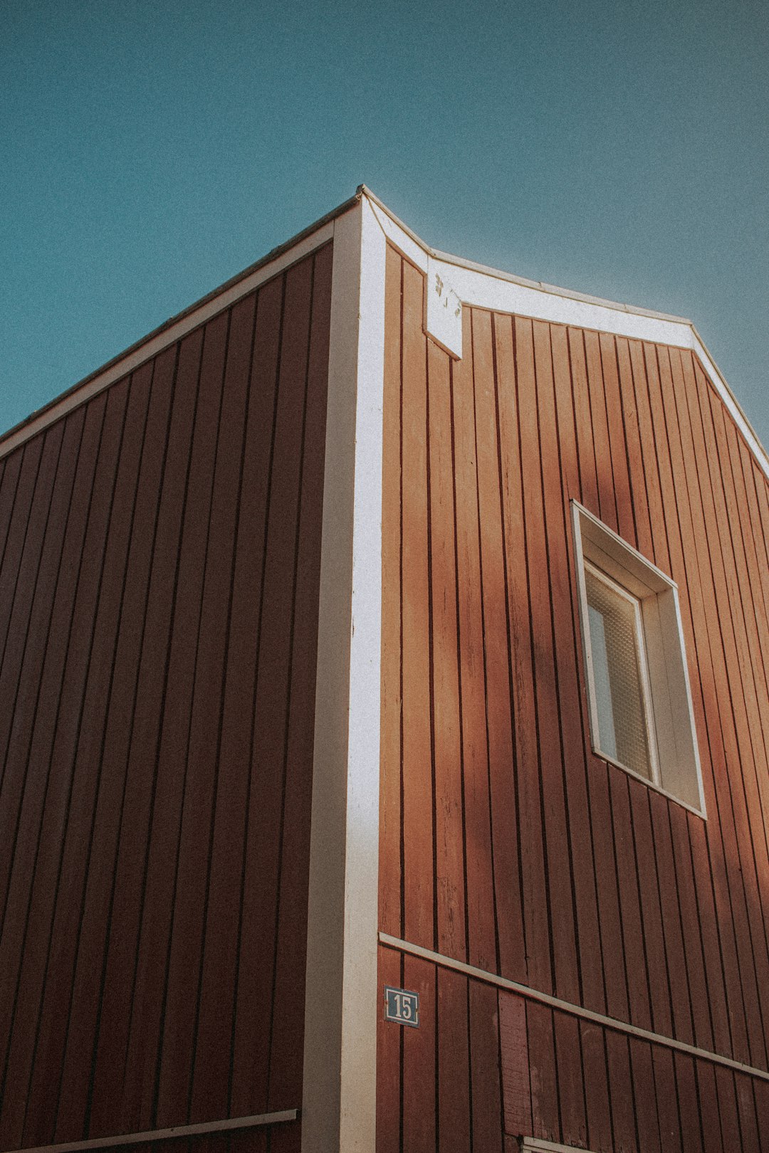 brown and white wooden house under blue sky during daytime