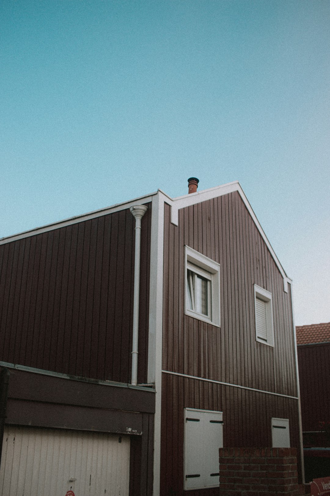 white and brown wooden house under blue sky during daytime