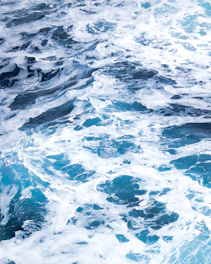 water waves on blue body of water during daytime