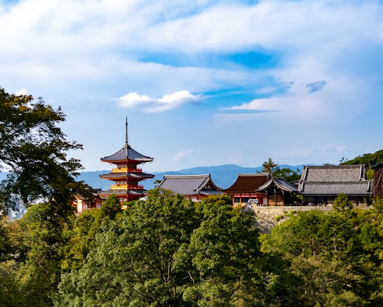 brown and black house surrounded by green trees under blue sky and white clouds during daytime in Kiyomizu-dera Japan
