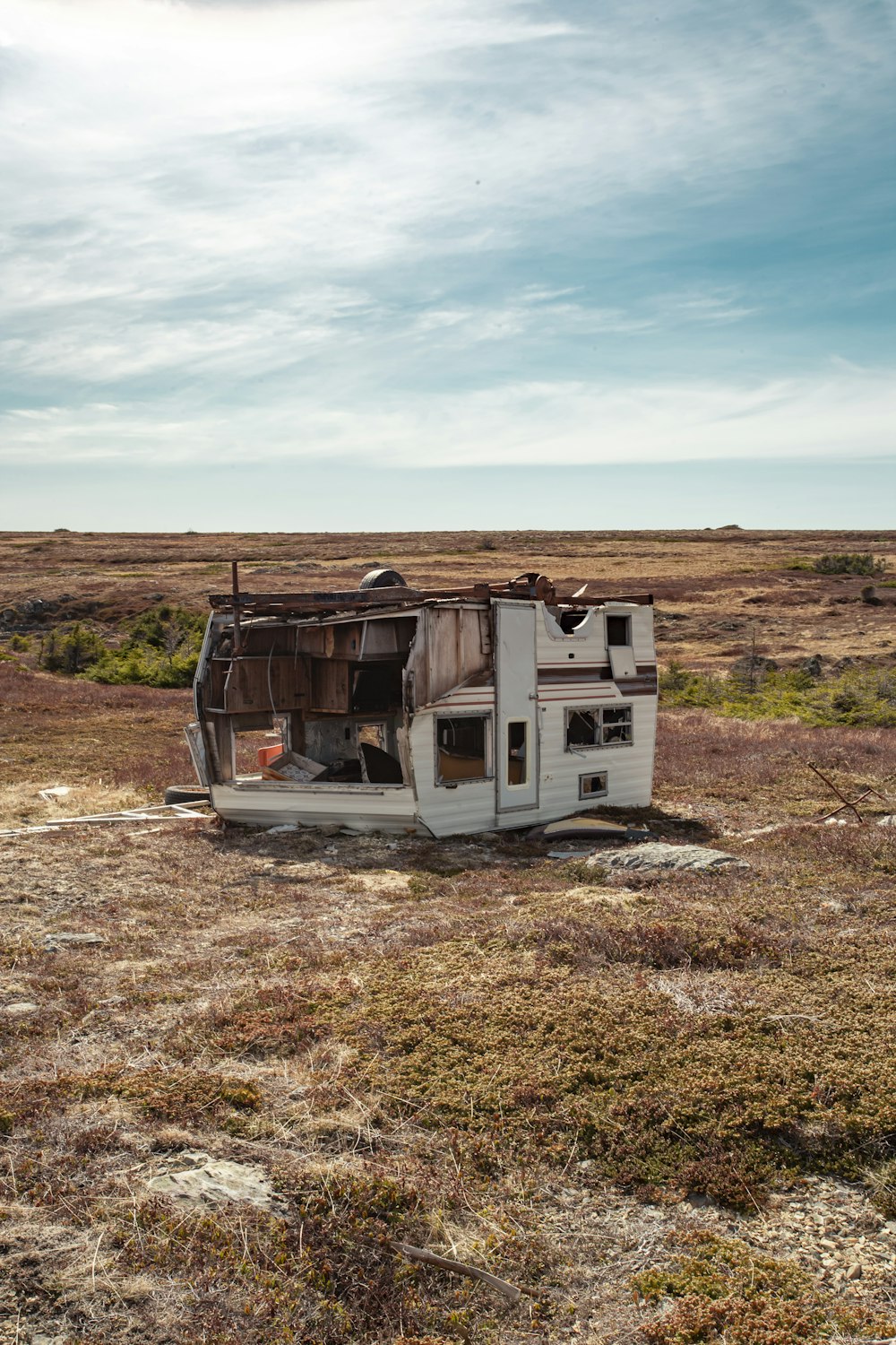 white and brown camper trailer on brown field under blue sky during daytime