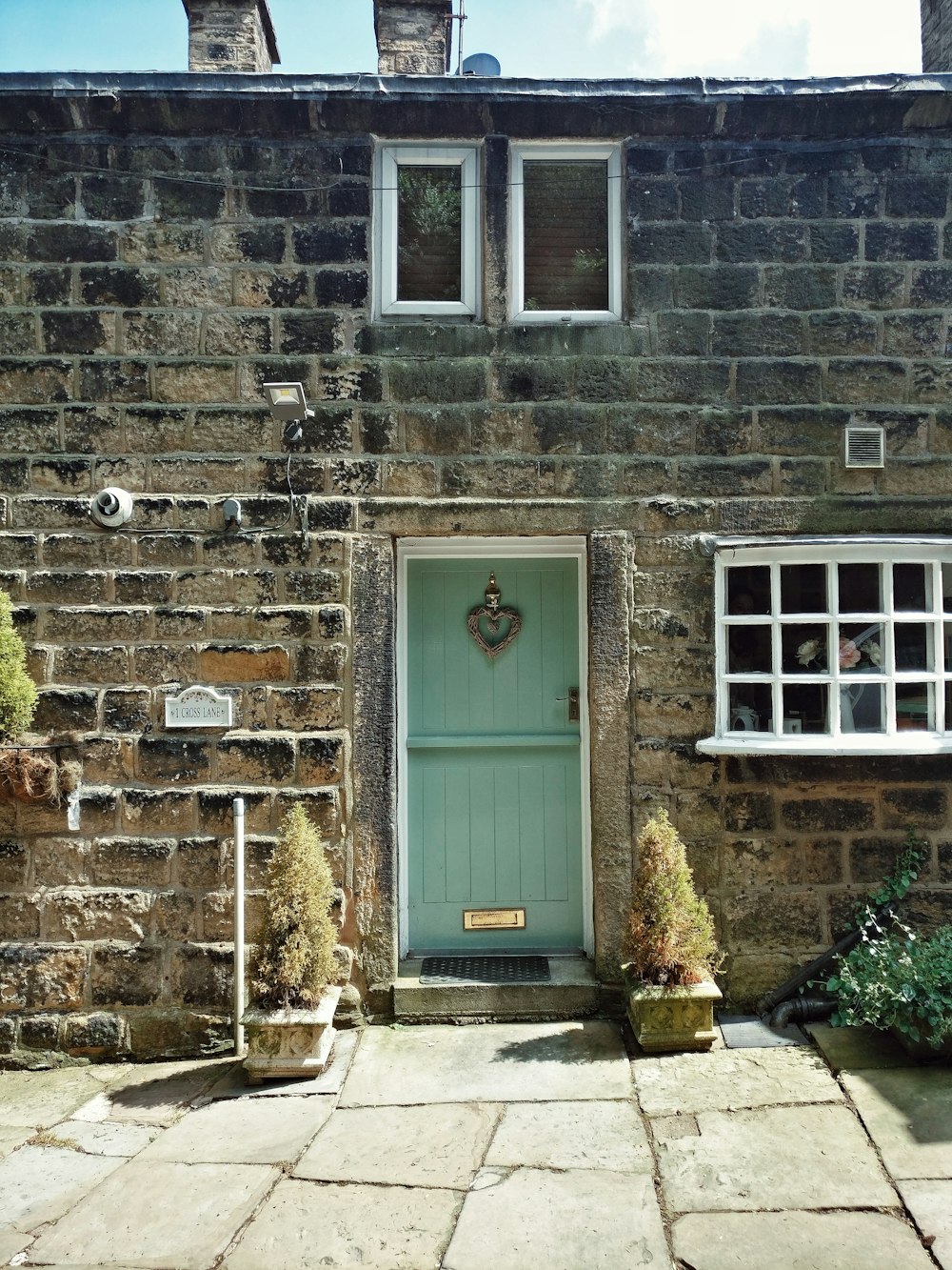 white wooden door on gray brick wall