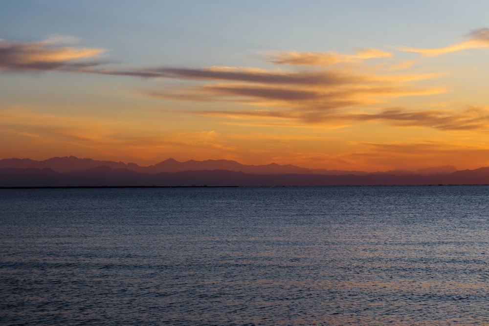 body of water during sunset