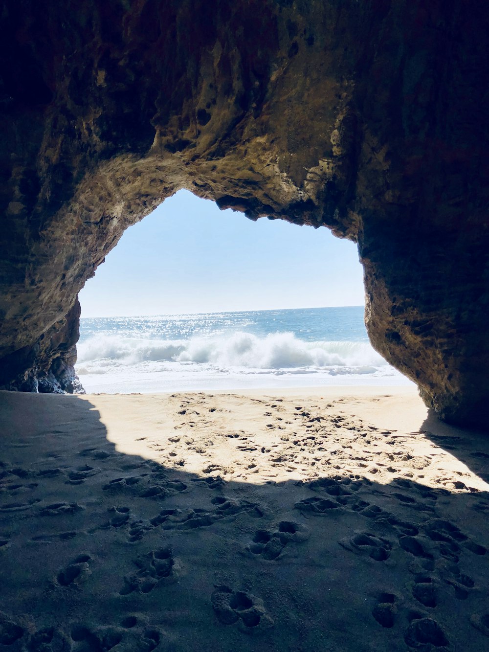 brown rock formation on beach during daytime