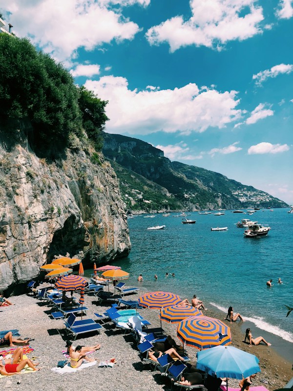 Beach umbrellas and clear water at Positano's Fornillo beach