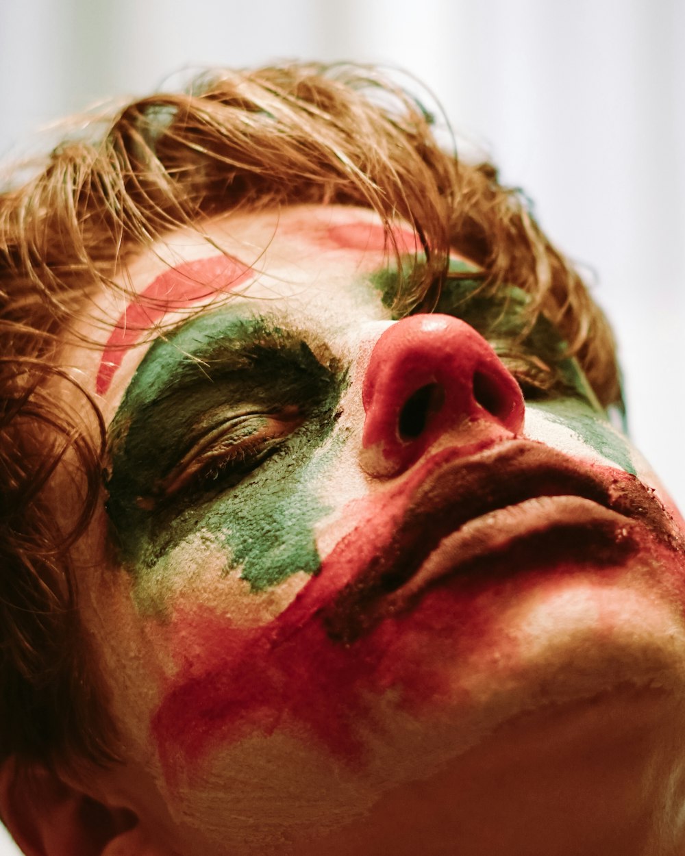 person with red and green face paint