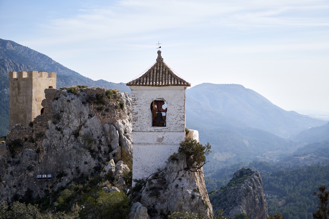 brown and white concrete church on top of mountain during daytime