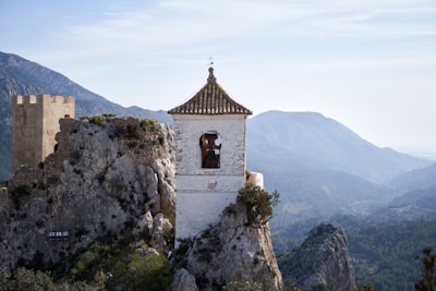 brown and white concrete church on top of mountain during daytime