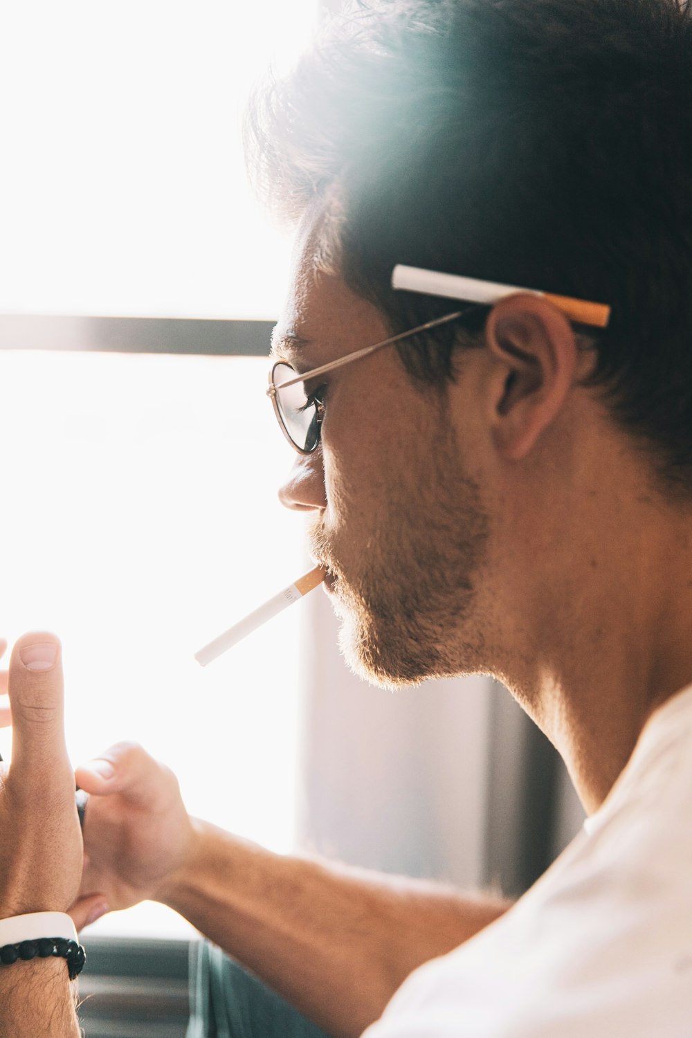 man in white shirt smoking