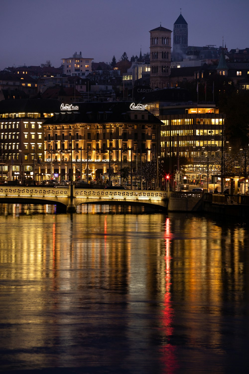 body of water near city buildings during night time