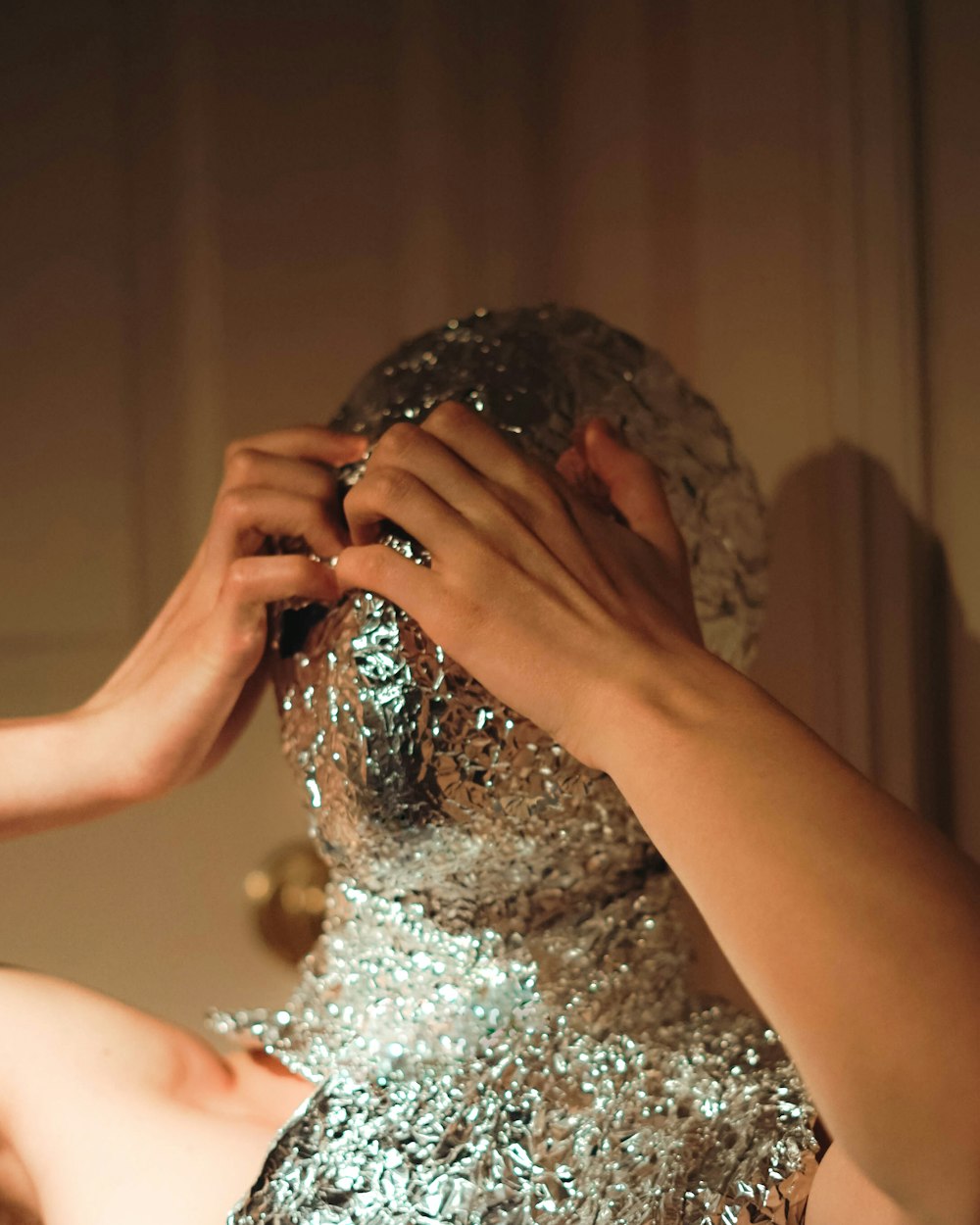 woman in white floral dress covering her face