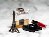 gold eiffel tower miniature on white textile