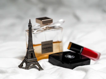 gold eiffel tower miniature on white textile