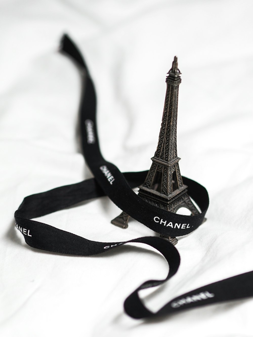 eiffel tower scale model on white textile