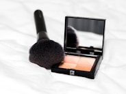 black make up palette on white textile