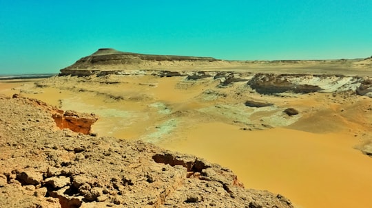 brown rock formation under blue sky during daytime in Siwa Egypt