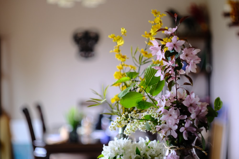 white and purple flowers on table