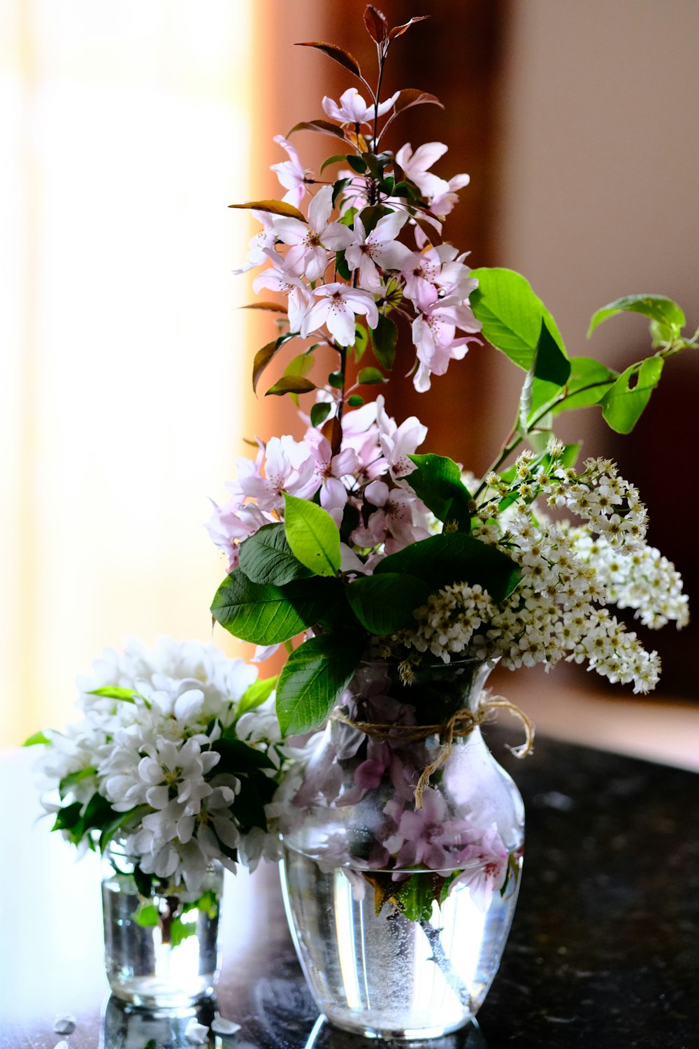 white and purple flowers in clear glass vase