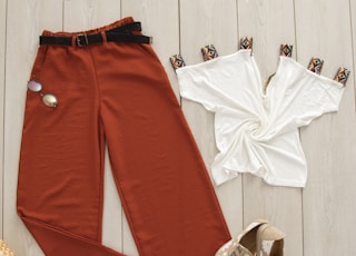 red pants on white wooden surface