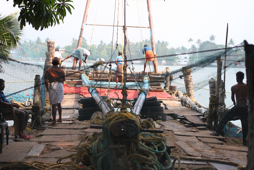 people standing on brown wooden dock during daytime