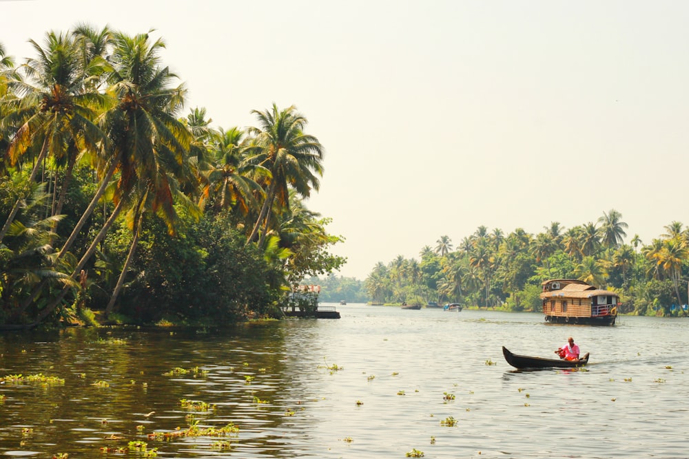 man riding on boat on lake during daytime