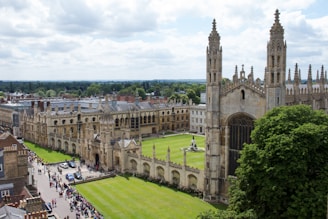 brown concrete building near green grass field during daytime