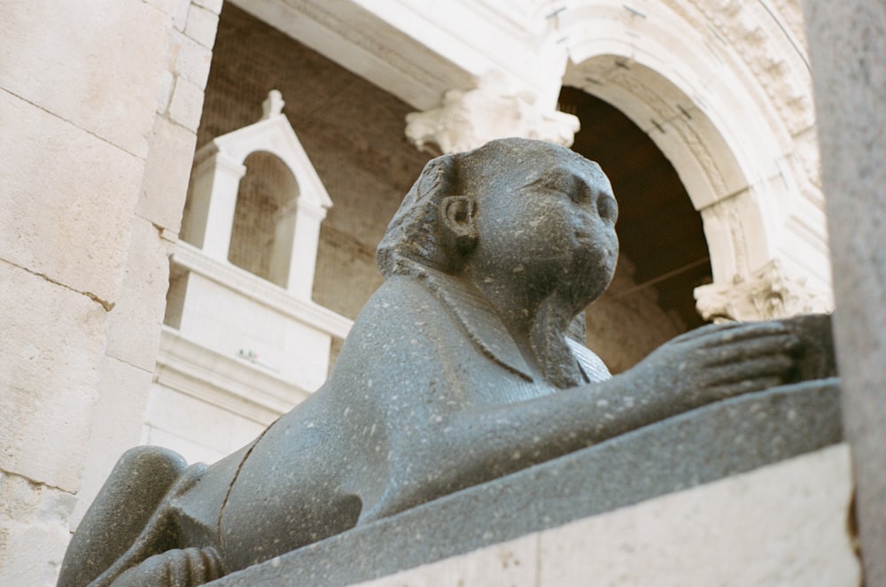 gray concrete statue of a woman