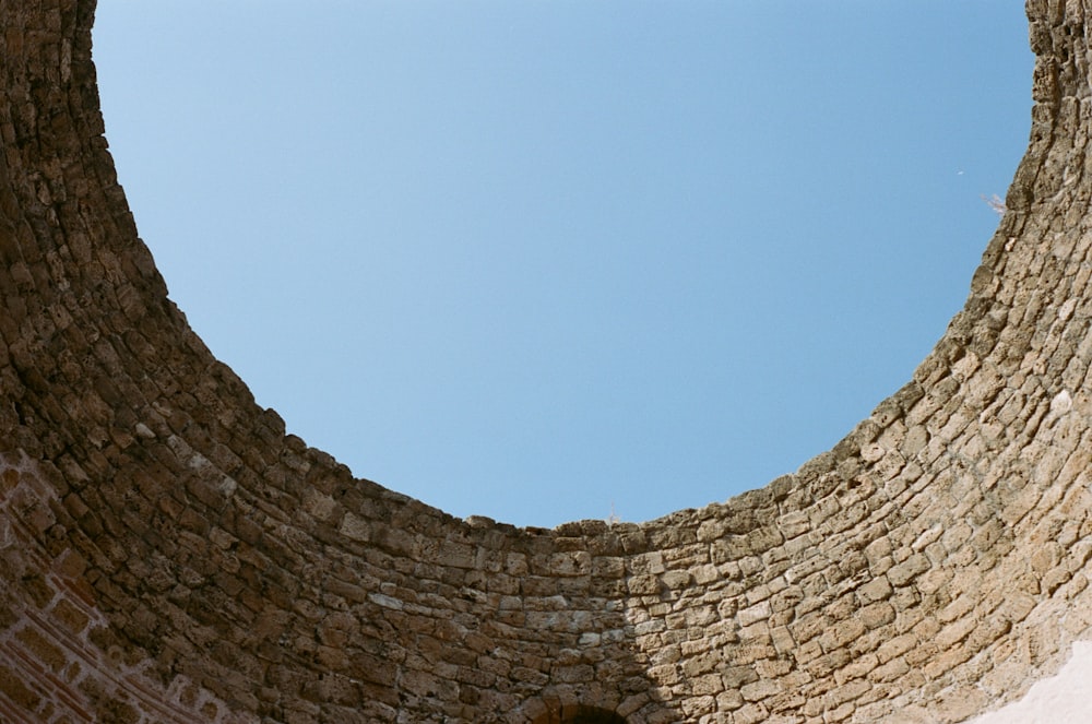 brown brick wall under blue sky during daytime