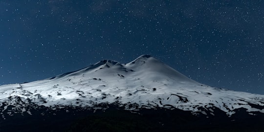 snow covered mountain under blue sky in Llaima Chile